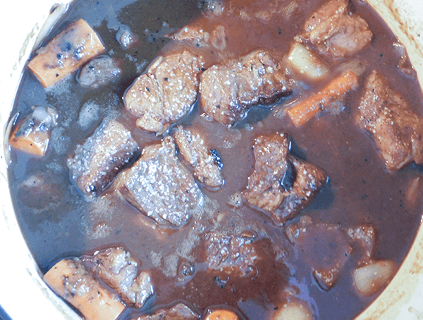 Seared beef cubes, carrots and onions ready for oven