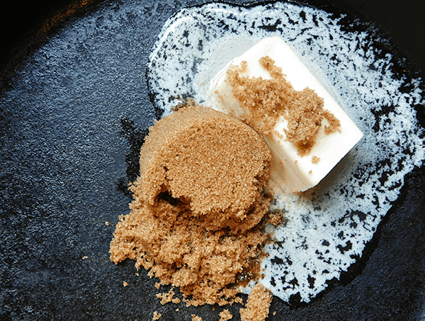 Butter and sugar melting in a cast iron skillet 